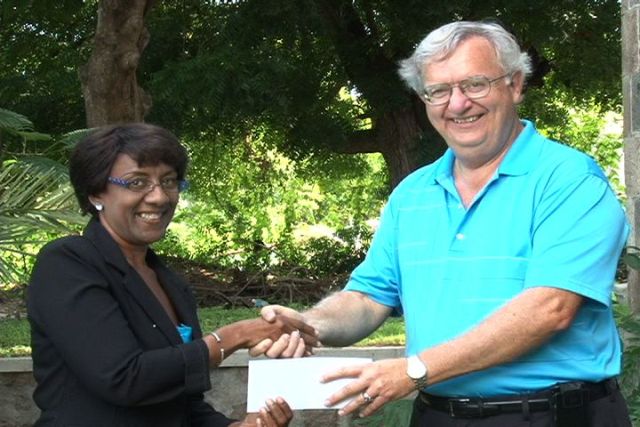 President of the Tarsus Trust Co. Ltd. Mr. Thomas “Tom” Ferneau hands over a cheque of over $US12, 000 on behalf of his Company and associates Alan and Jayneen Ross of Oklahoma, to the Society’s Treasurer Ms. Paulette Hanley